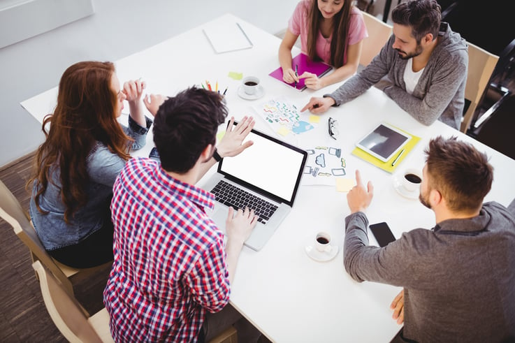 High angle view of young partners discussing in meeting room at creative office-1