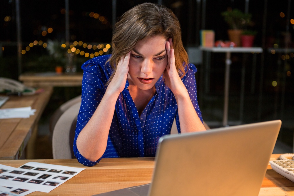 Stressed businesswoman sitting at her desk in the office